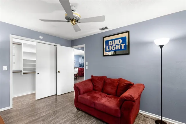 a bathroom with a granite countertop sink a toilet a mirror a bathtub and shower