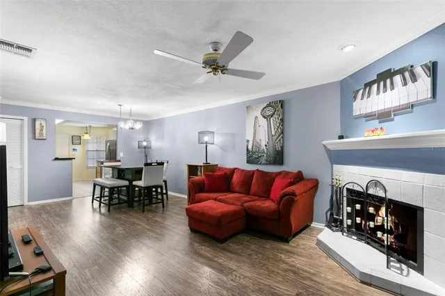 a living room with furniture a fireplace and a window