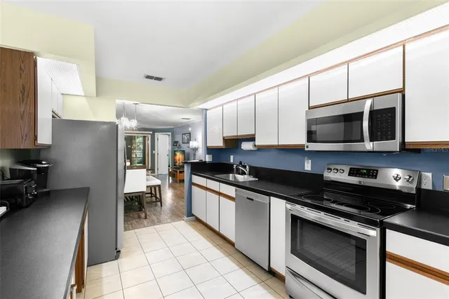 a kitchen with stainless steel appliances granite countertop a stove and a microwave