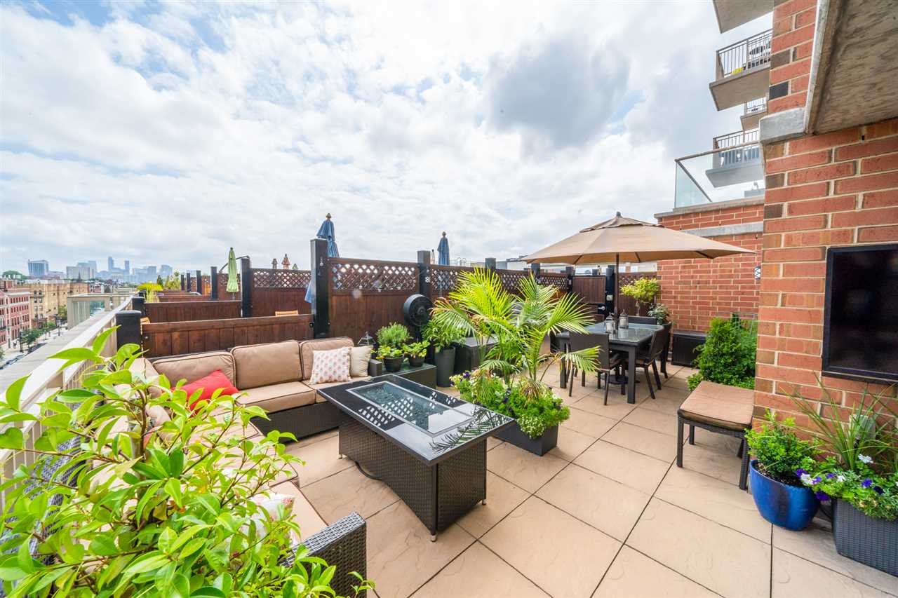 1450 Washington Street, Unit 708 Hoboken, NJ 07030 - Photo 1 of 1 a view of a tables and chairs in the terrace