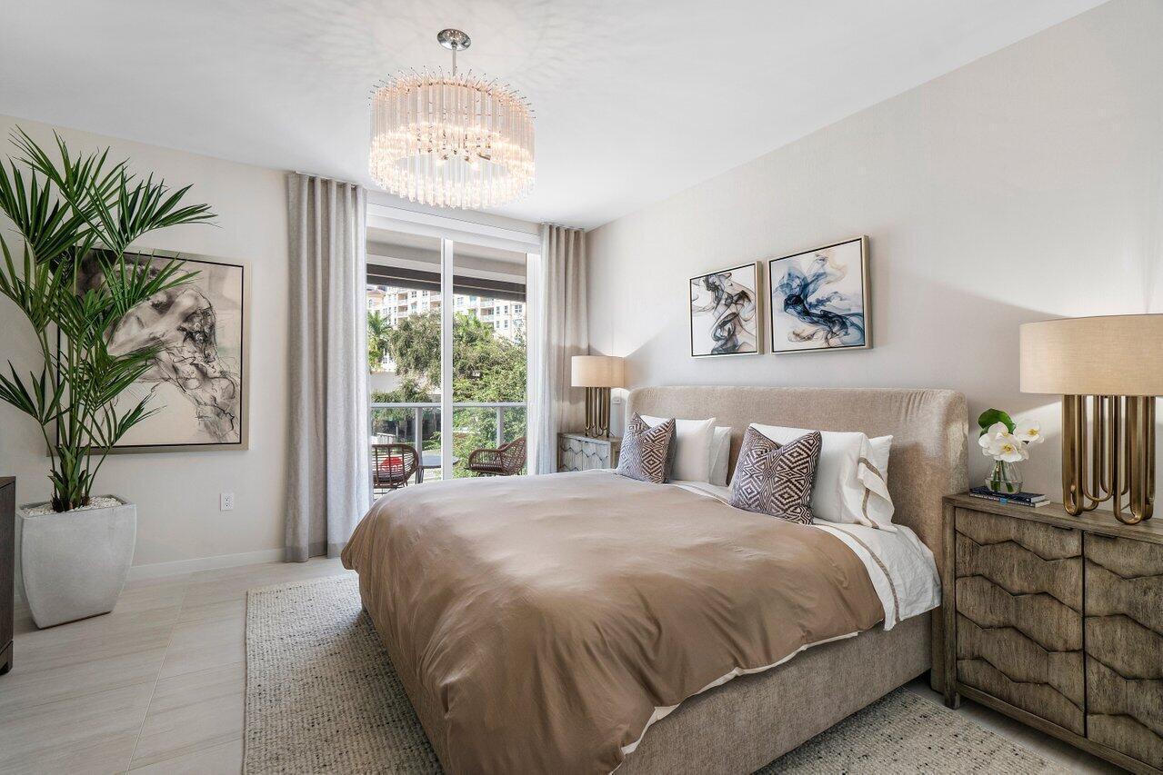 200 Southeast Mizner Boulevard, Unit 211 Boca Raton, FL 33432 - Photo 17 of 67 a spacious bedroom with a large bed and a window