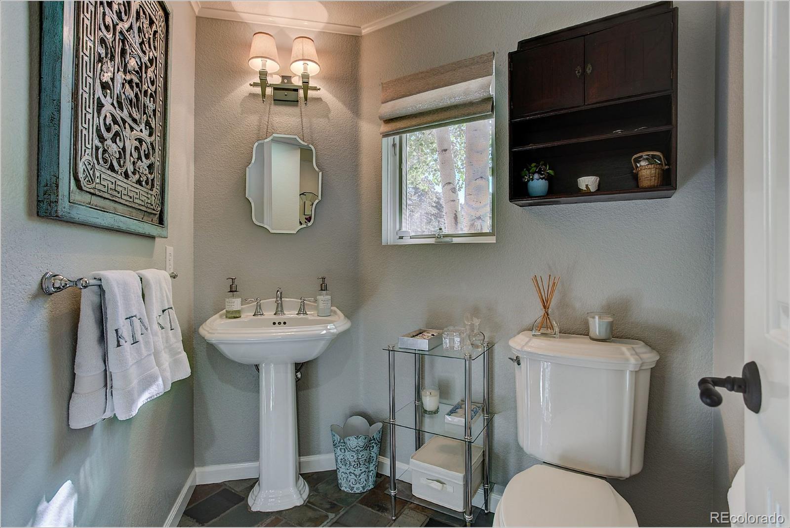 1559 Kerr Gulch Road Evergreen, CO 80439 - Photo 17 of 34 a bathroom with a toilet sink and mirror