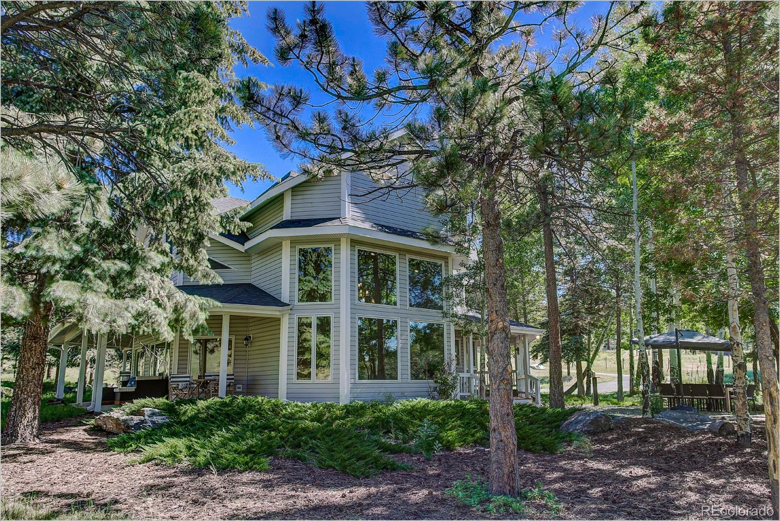 1559 Kerr Gulch Road Evergreen, CO 80439 - Photo 34 of 34 a front view of a house with a garden