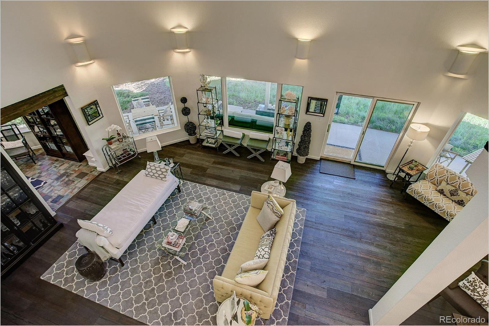 1559 Kerr Gulch Road Evergreen, CO 80439 - Photo 9 of 34 a living room with furniture and a wooden floor