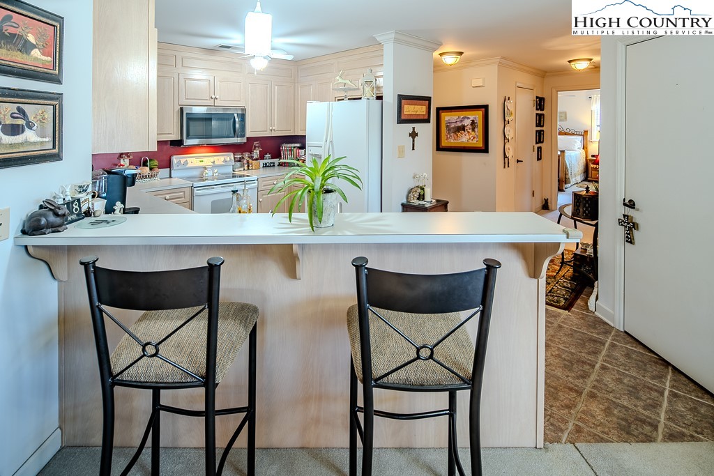 151 Deer Valley Drive, Unit 231 Boone, NC 28607 - Photo 19 of 35 a kitchen with a table and chairs in it