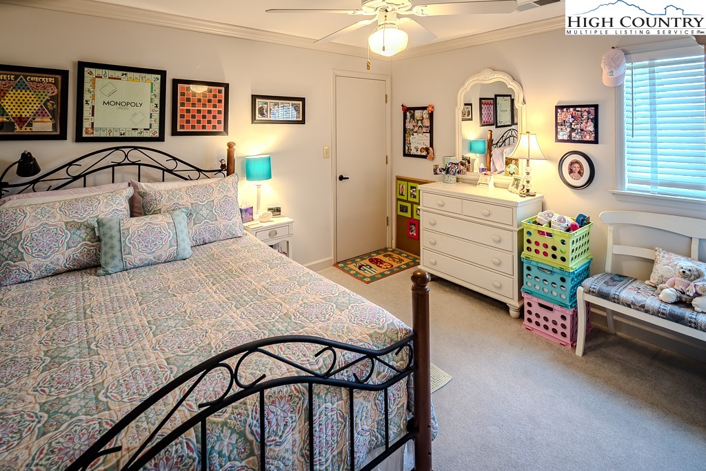 151 Deer Valley Drive, Unit 231 Boone, NC 28607 - Photo 28 of 35 a bedroom with a bed and a dresser in it