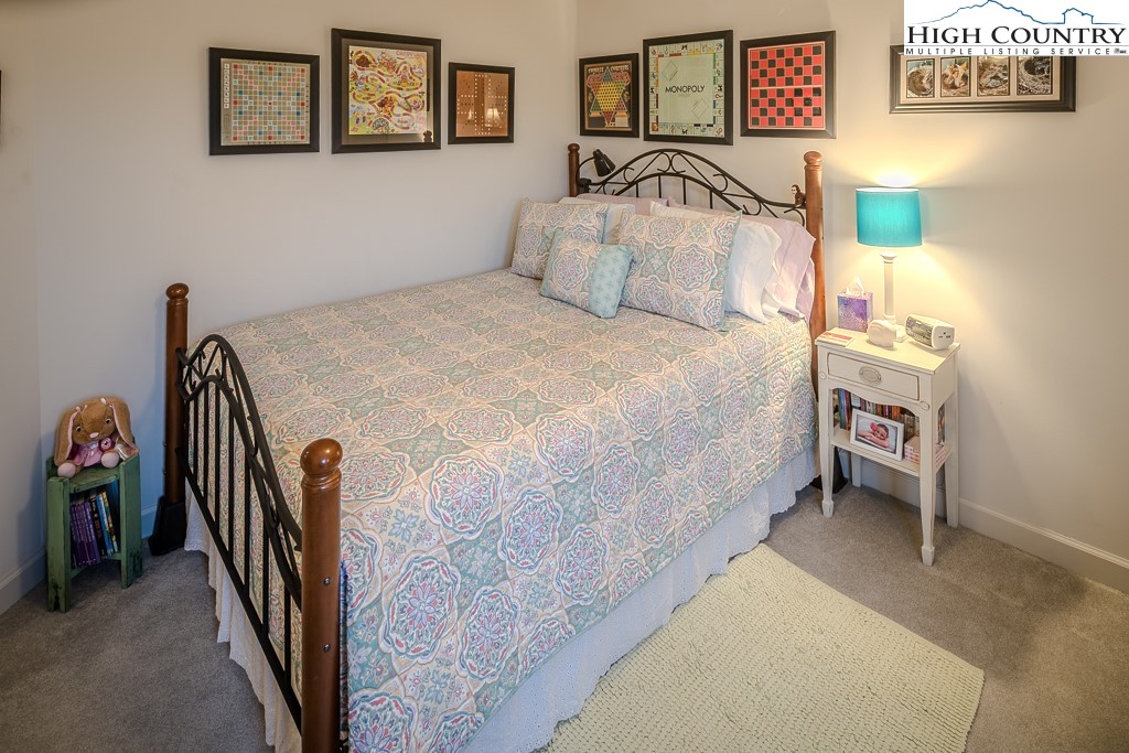 151 Deer Valley Drive, Unit 231 Boone, NC 28607 - Photo 29 of 35 a bedroom with a bed and a table