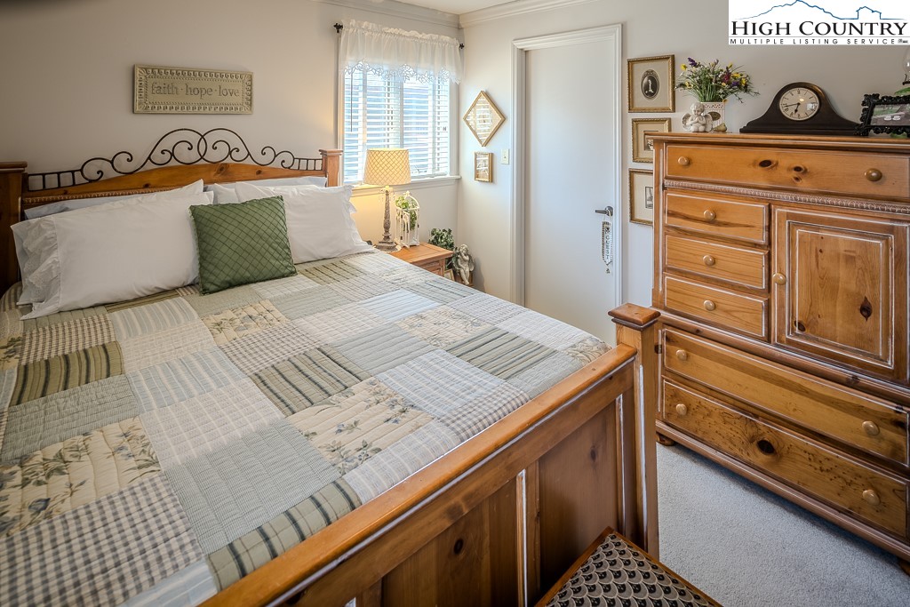 151 Deer Valley Drive, Unit 231 Boone, NC 28607 - Photo 34 of 35 a bedroom with a bed and a dresser