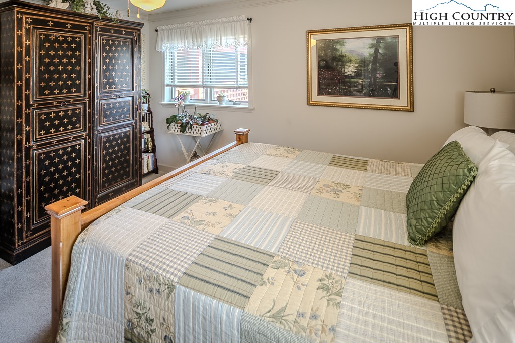 151 Deer Valley Drive, Unit 231 Boone, NC 28607 - Photo 35 of 35 a bedroom with a bed and a painting on the wall