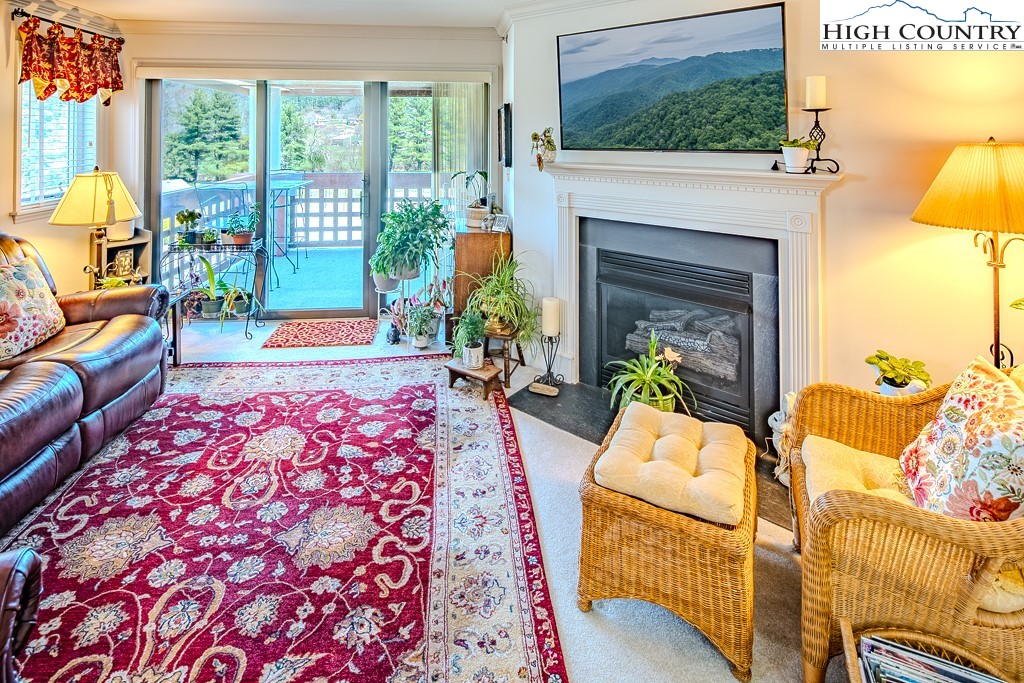 151 Deer Valley Drive, Unit 231 Boone, NC 28607 - Photo 7 of 35 a living room with furniture and a fireplace