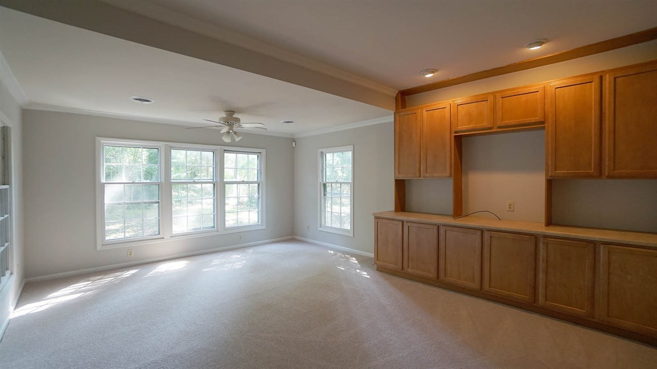 1421 Lynn Road Raleigh, NC 27612 - Photo 27 of 30 Family room, with brand new carpet & fresh paint, built ins and plenty of light. In-law Guest House-Family Room
