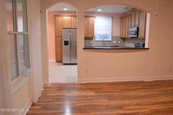 a view of empty room with wooden floor and yard