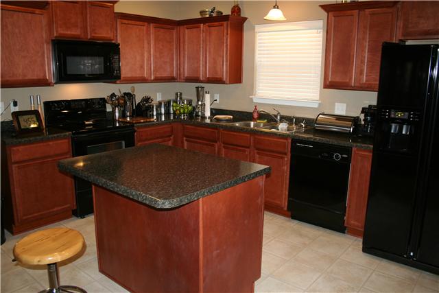 3717 Shoteka Drive Murfreesboro, TN 37128 - Photo 14 of 19 a kitchen with stainless steel appliances granite countertop a sink a stove a refrigerator a microwave and cabinets
