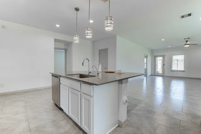 a kitchen with stainless steel appliances kitchen island a white cabinets and sink