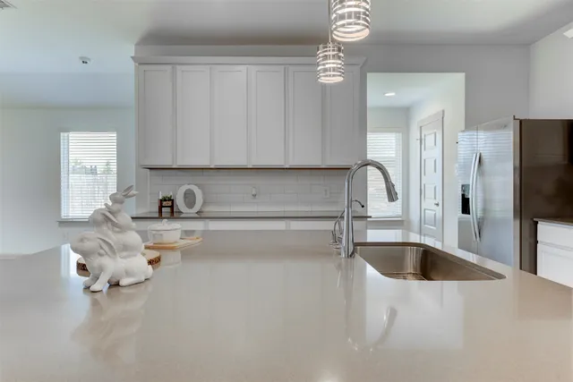 a kitchen with center island table and chairs