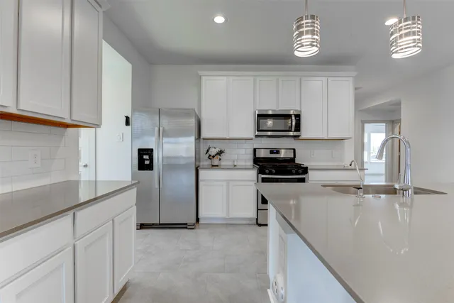 a kitchen with a sink and cabinets