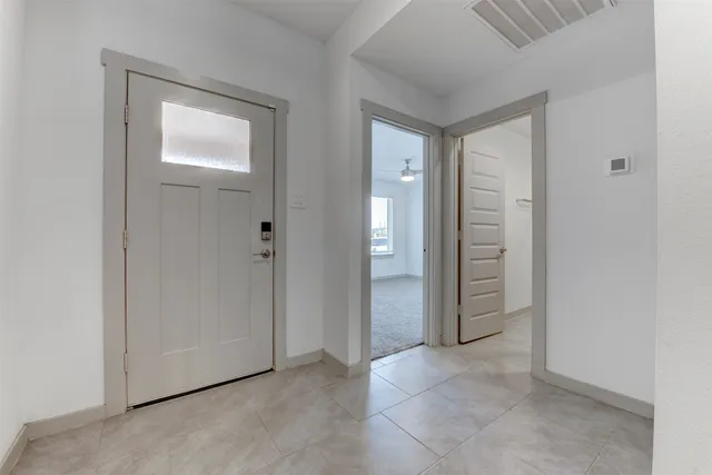 an empty room with closet and mirror