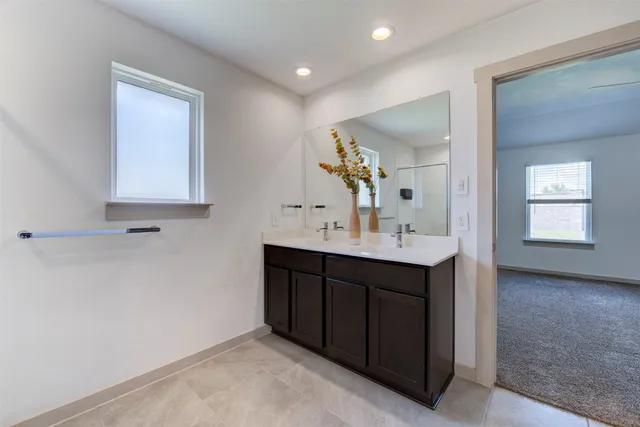 a bathroom with a sink vanity and mirror