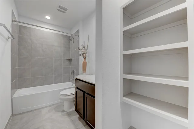 a bathroom with a toilet and a bathtub