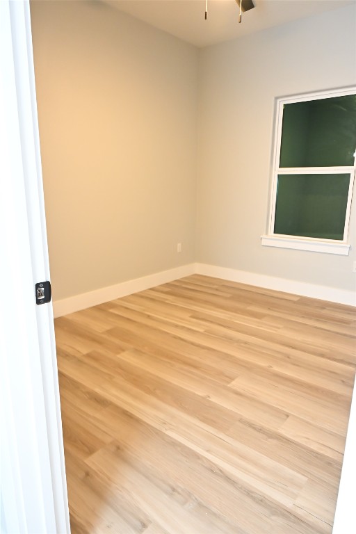 516 North Hackberry Avenue Luling, TX 78648 - Photo 22 of 36 Spare room with light wood-style floors and baseboards