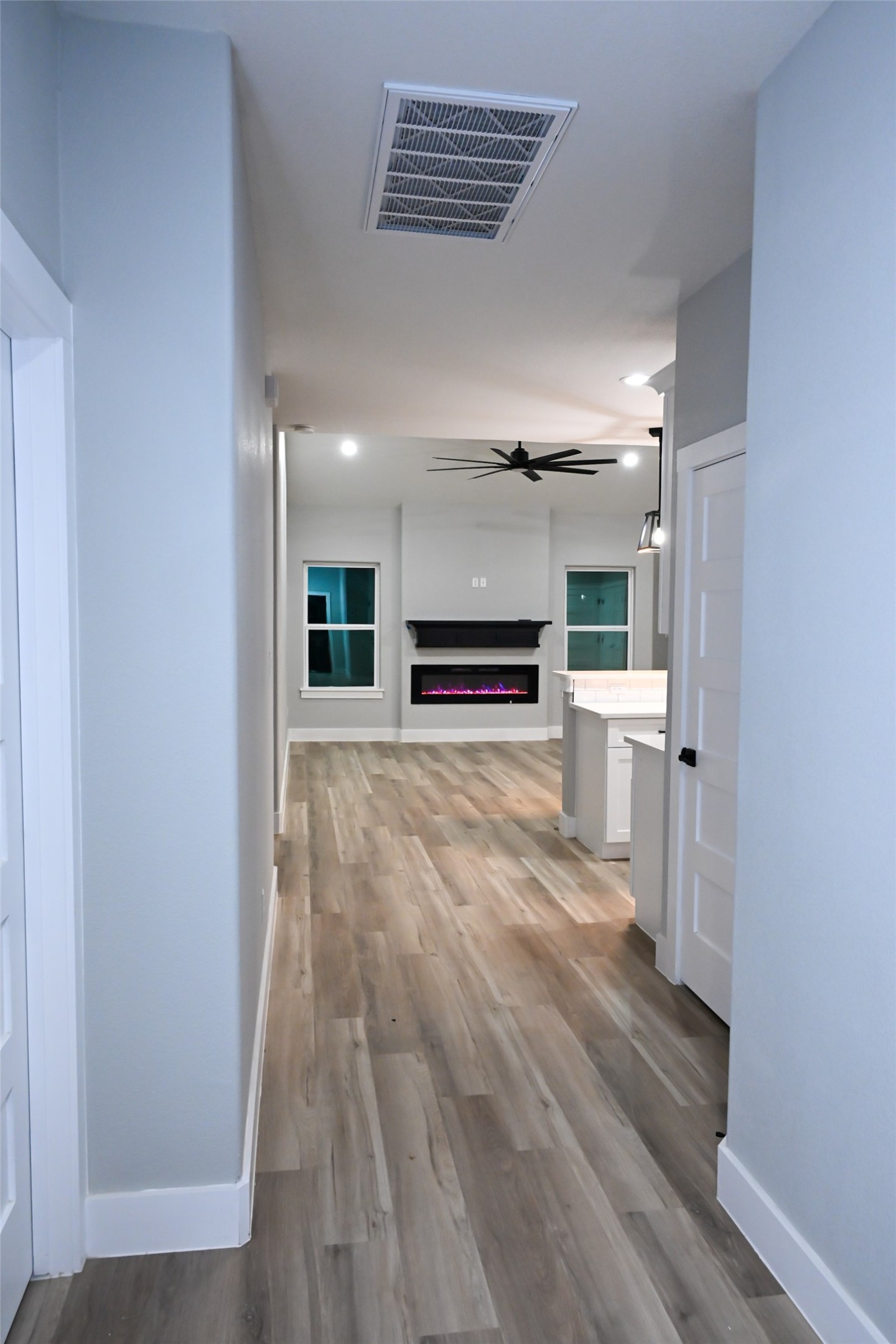 516 North Hackberry Avenue Luling, TX 78648 - Photo 25 of 36 wooden floor in an empty room with a kitchen