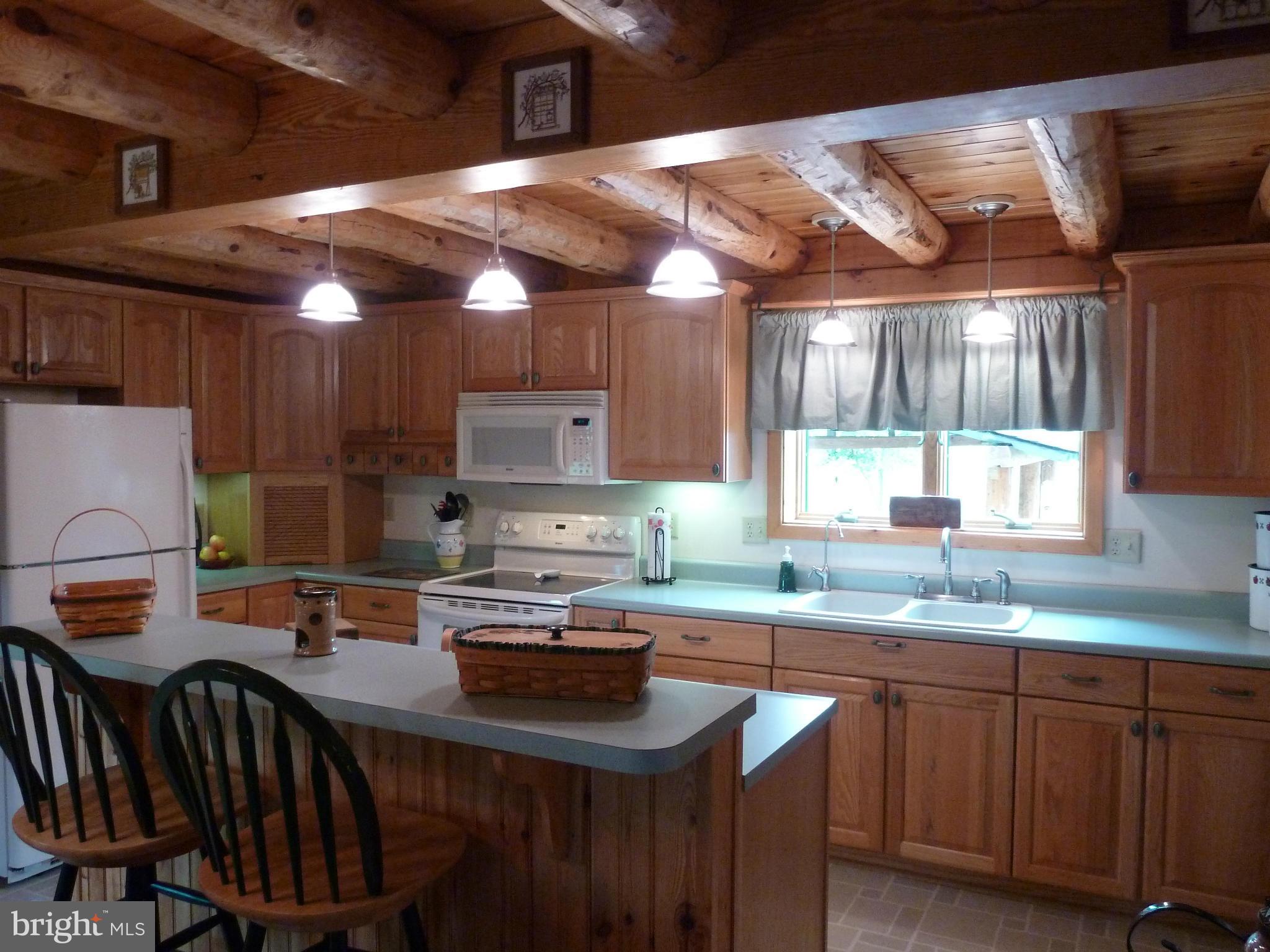 11682 Rocky Meadow Road Clear Spring, MD 21722 - Photo 2 of 30 a kitchen with sink a microwave a stove and cabinets