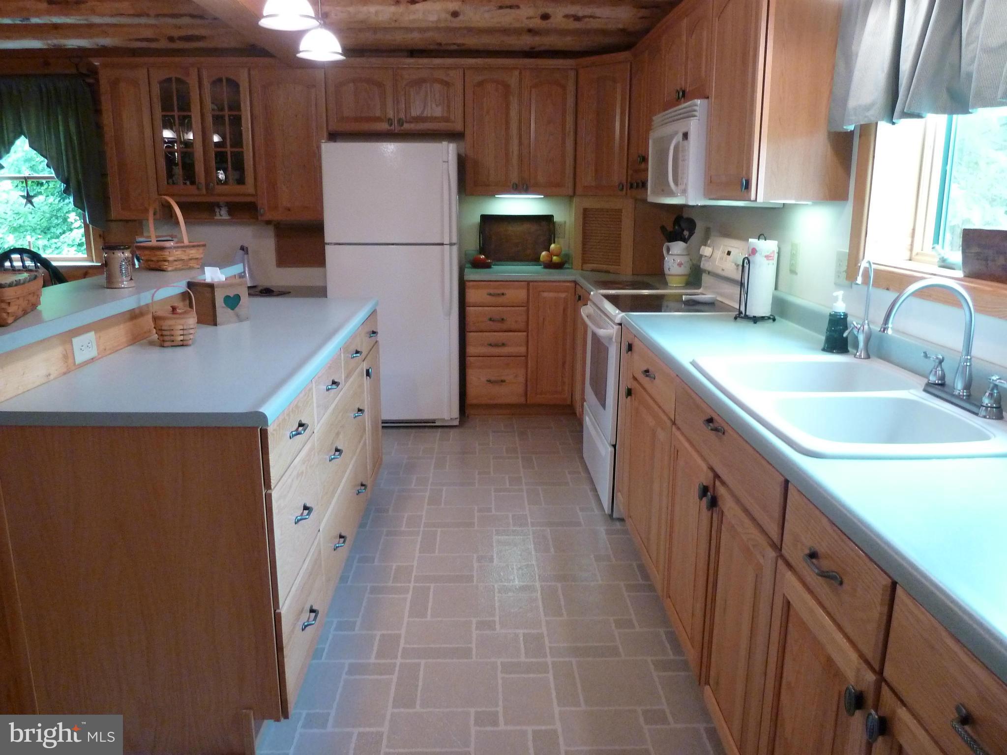 11682 Rocky Meadow Road Clear Spring, MD 21722 - Photo 3 of 30 a kitchen with granite countertop a sink stove and cabinets