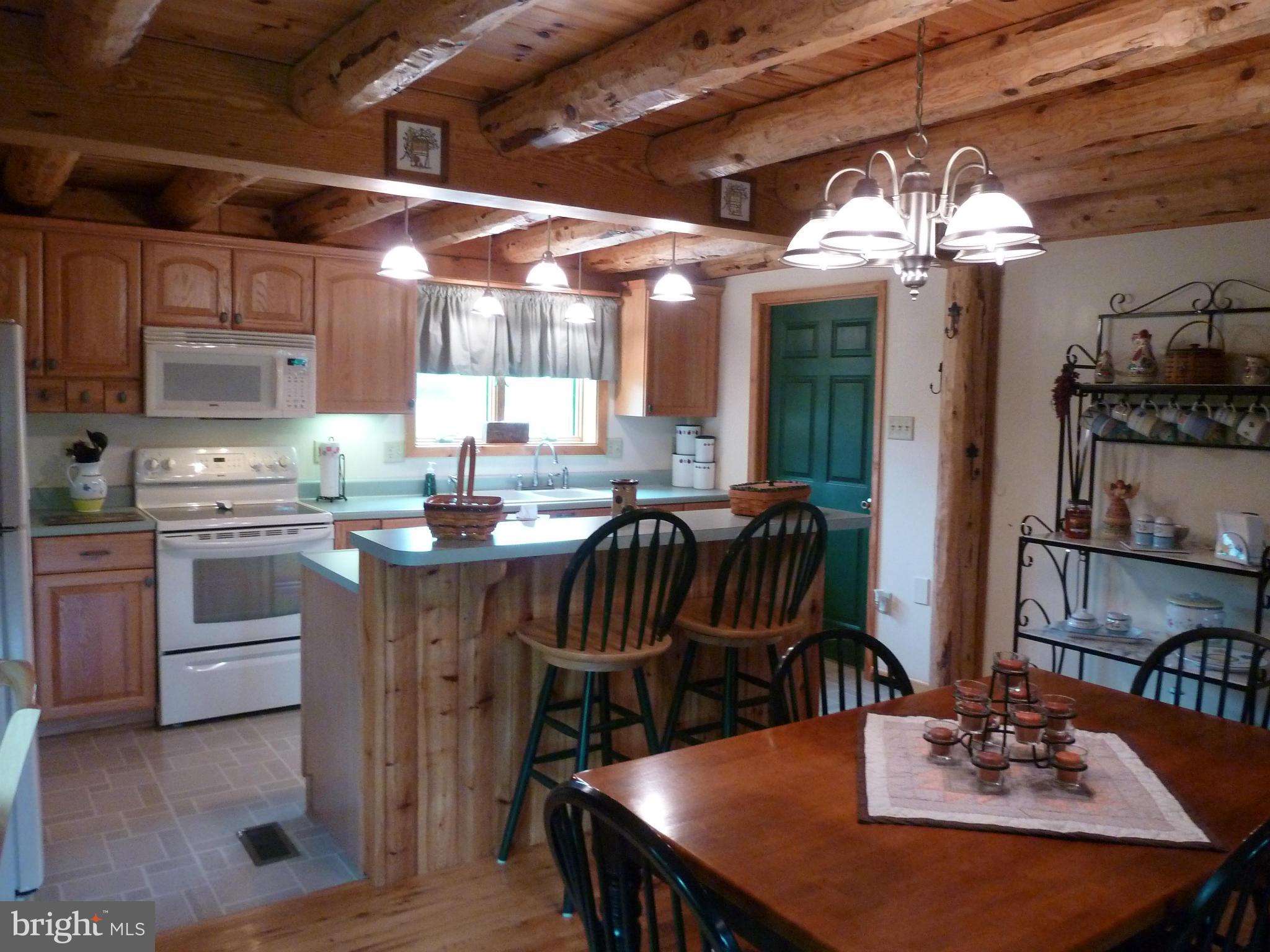 11682 Rocky Meadow Road Clear Spring, MD 21722 - Photo 4 of 30 a kitchen with a table chairs stove and cabinets
