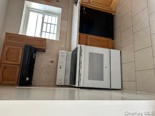 338 Beach 87th Street, Unit 1 Queens, NY 11693 - Photo 4 of 5 a stove top oven sitting inside of a kitchen
