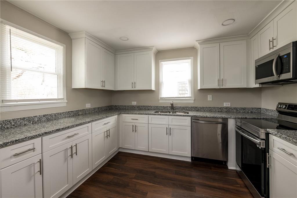 1854 Broadwell Street Southwest Atlanta, GA 30310 - Photo 15 of 18 a kitchen with granite countertop cabinets stainless steel appliances a sink and window