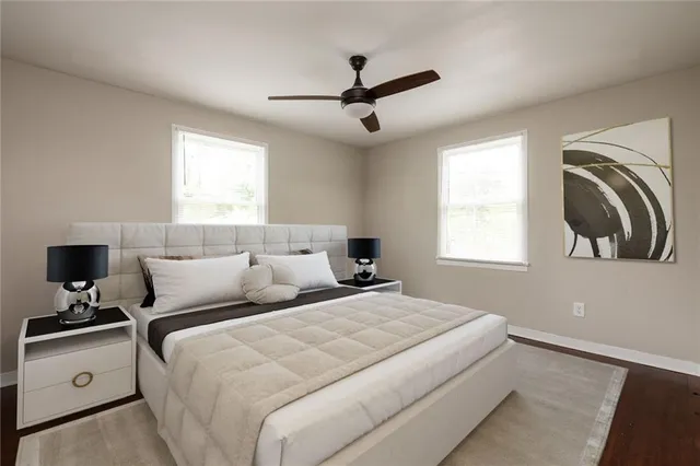 a view of empty room with wooden floor and window