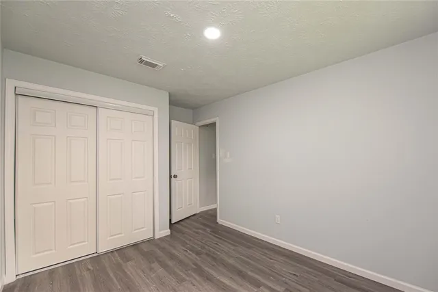 a view of an empty room and wooden floor