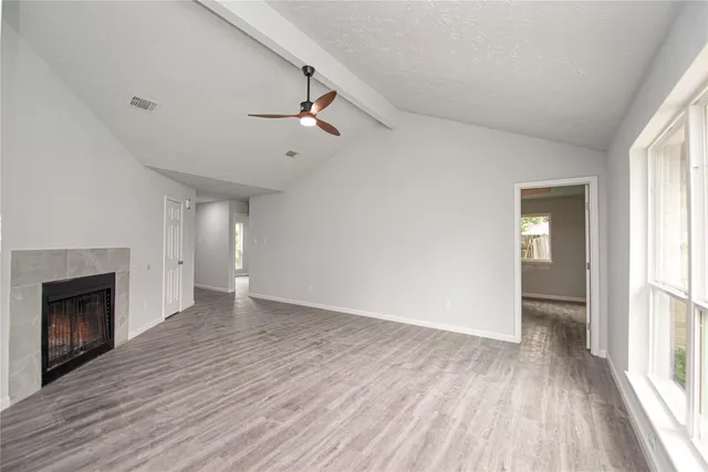 wooden floor in an empty room with a window