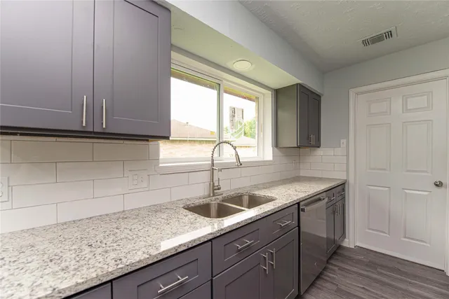 a kitchen with a sink and cabinets