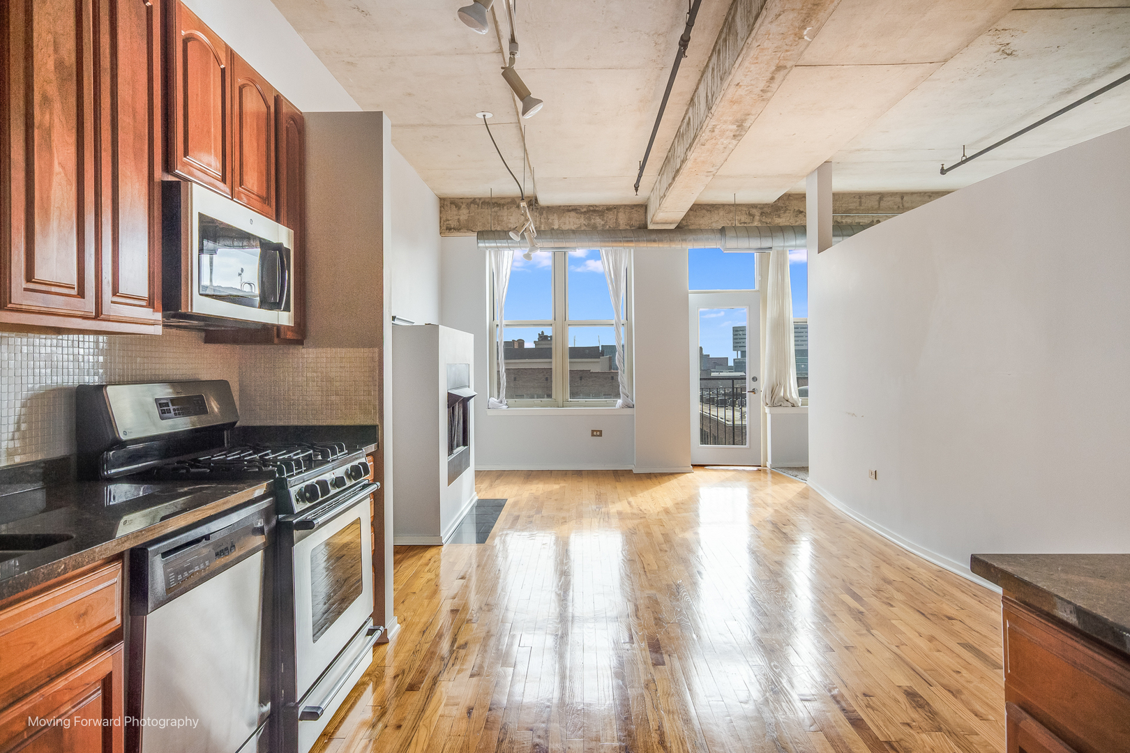 6 South Laflin Street, Unit 923 Chicago, IL 60607 - Photo 5 of 19 a kitchen with stainless steel appliances granite countertop a stove and a refrigerator