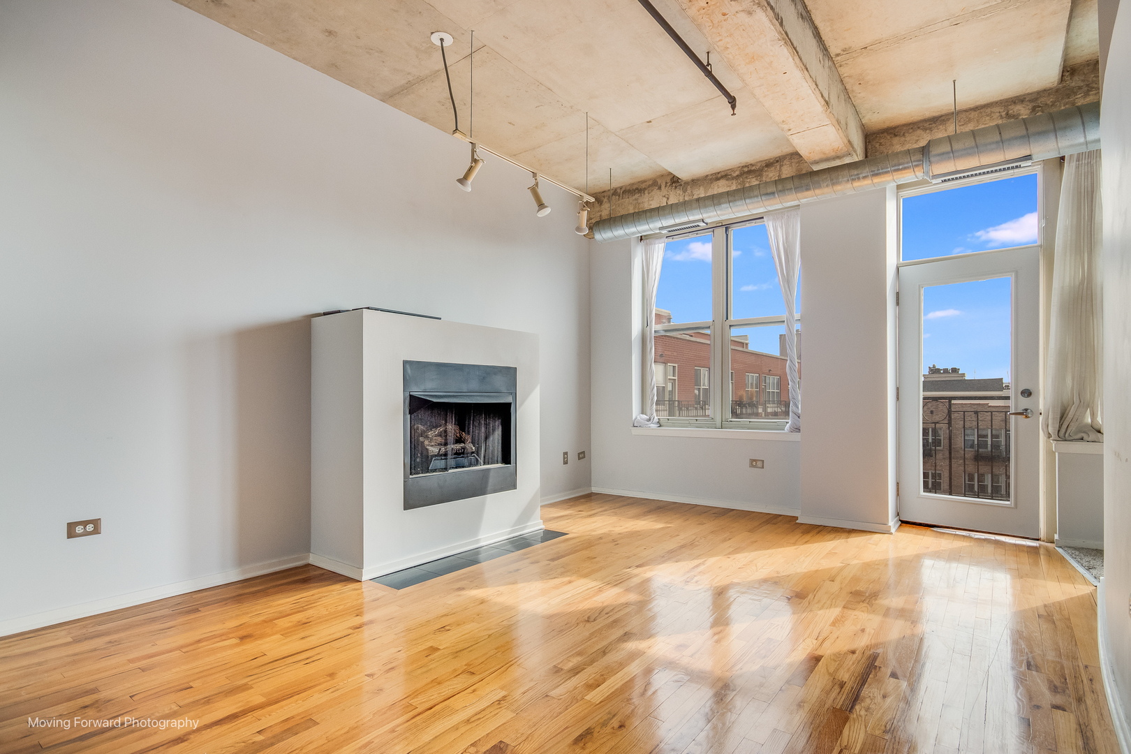 6 South Laflin Street, Unit 923 Chicago, IL 60607 - Photo 10 of 19 a view of an empty room with a fireplace and a window