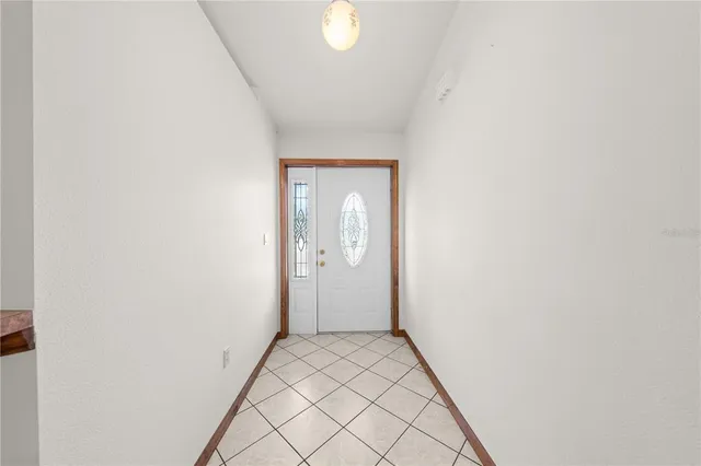 a view of a dining room with furniture and a chandelier