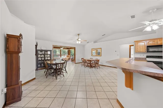 a view of a dining room with furniture and chandelier