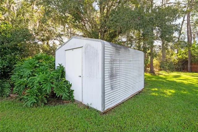 a view of a house with a backyard porch and sitting area