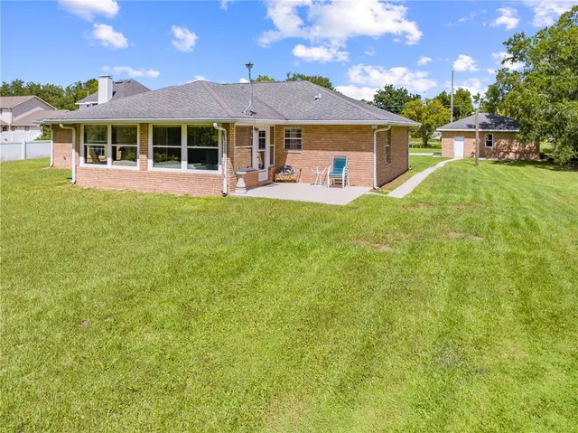 a front view of a house with a garden and yard