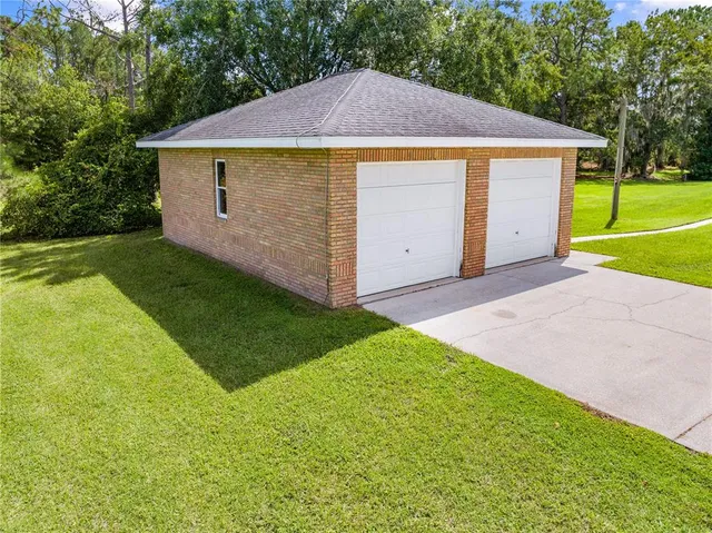 a front view of house with yard and trees