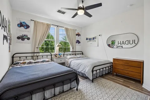 a bedroom with two beds and a window