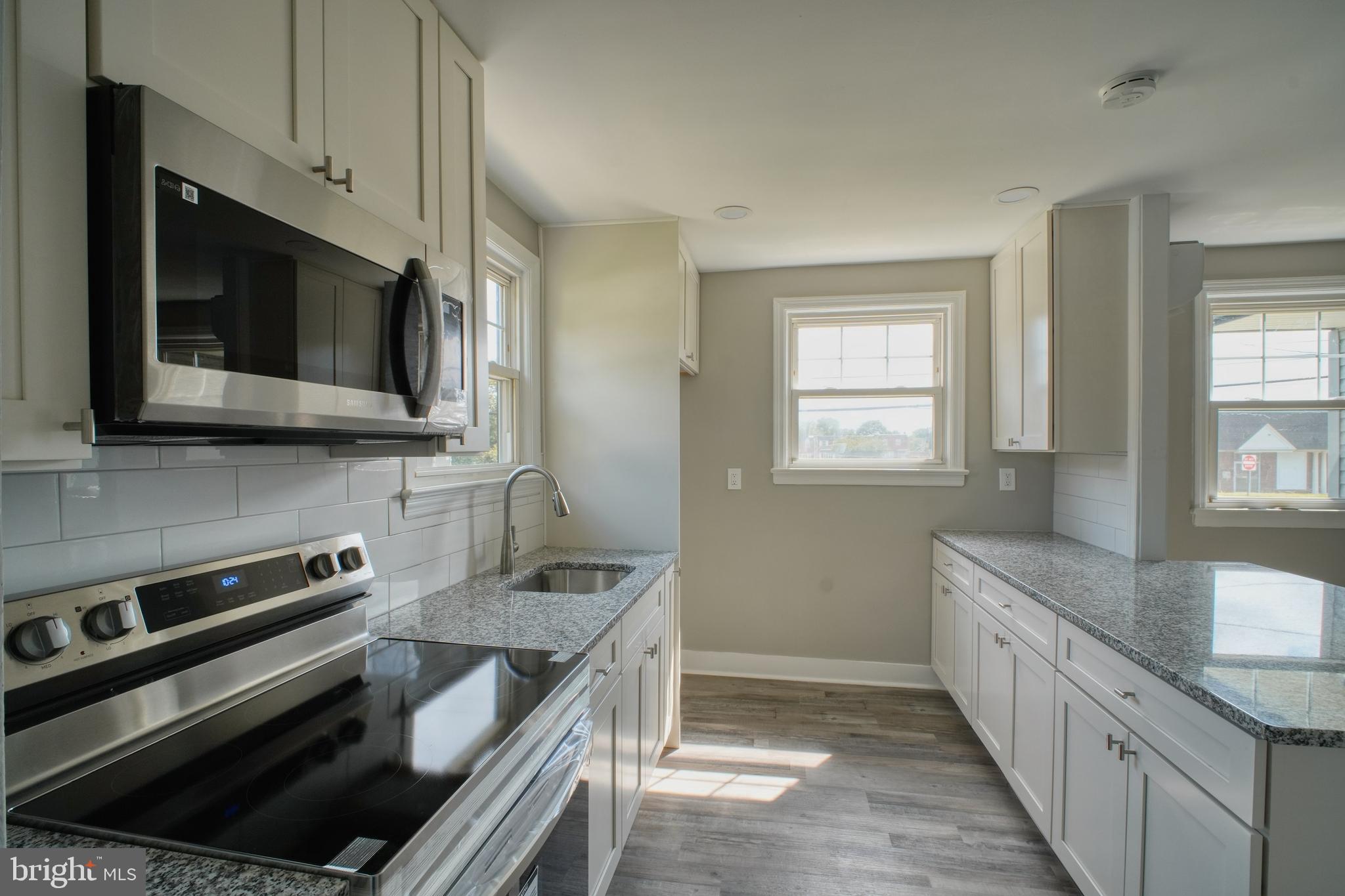 3220 Byberry Road Philadelphia, PA 19154 - Photo 7 of 31 a kitchen with stainless steel appliances a stove microwave and sink