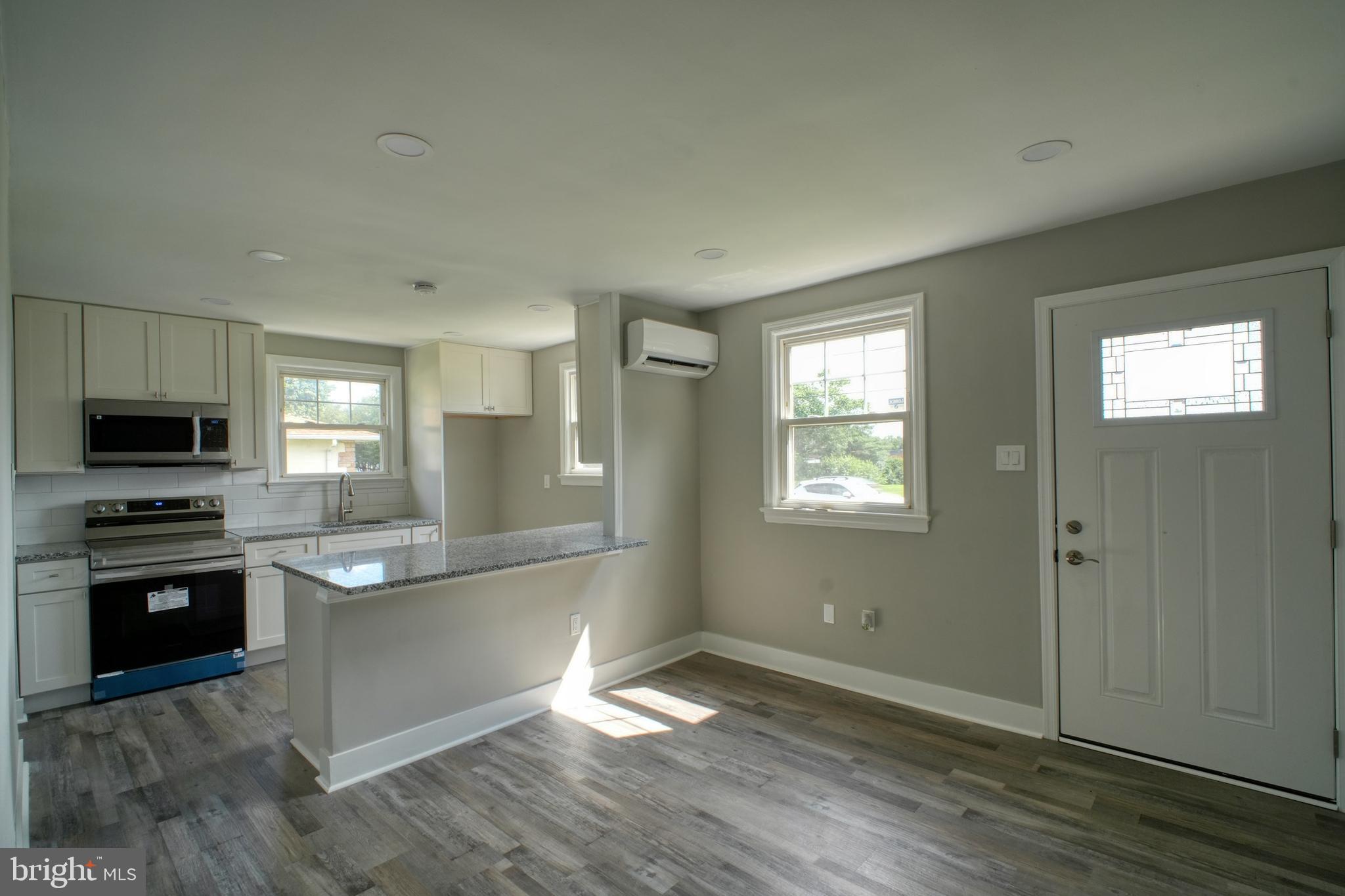 3220 Byberry Road Philadelphia, PA 19154 - Photo 9 of 31 a kitchen with granite countertop a stove and a refrigerator