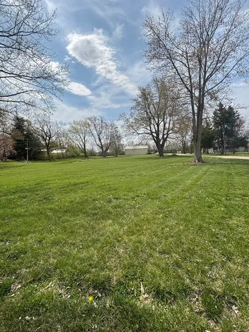 a view of a field with an trees