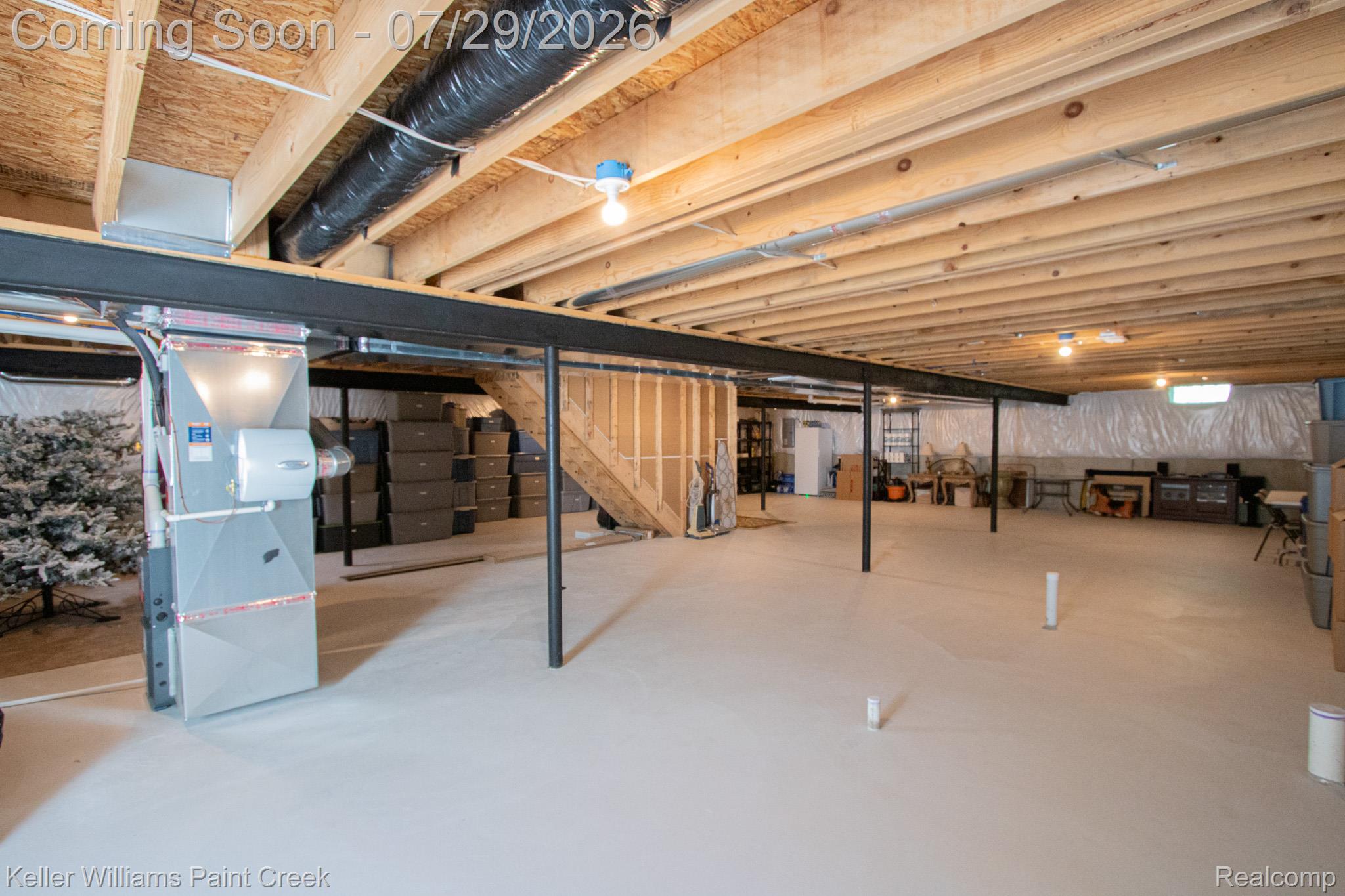 49118 Ridgeview Drive Macomb, MI 48044 - Photo 38 of 57 Unfinished basement with open wooden joist ceiling, concrete flooring, and exposed structural steel beams