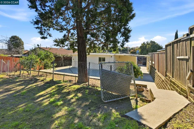 a view of a deck with chairs and wooden fence