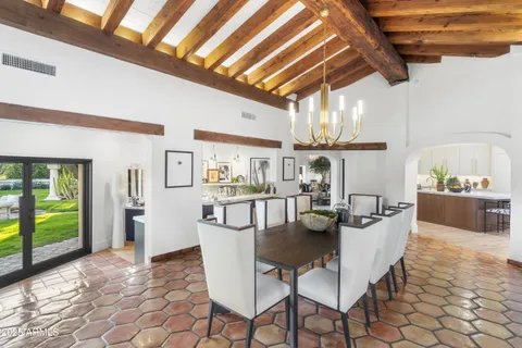 a living room with furniture a flat screen tv and a wall painting