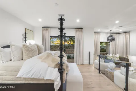 a white house with a big yard and palm trees