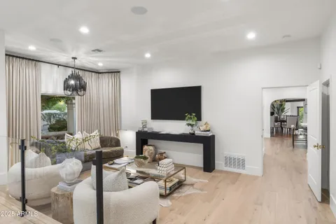 a living room with furniture and a floor to ceiling window